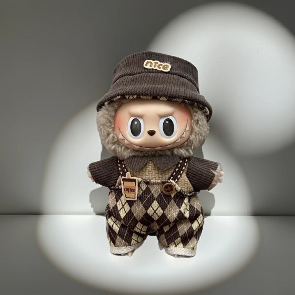 Toy figure in a brown outfit with 'nice' hat and suspenders on a gray background